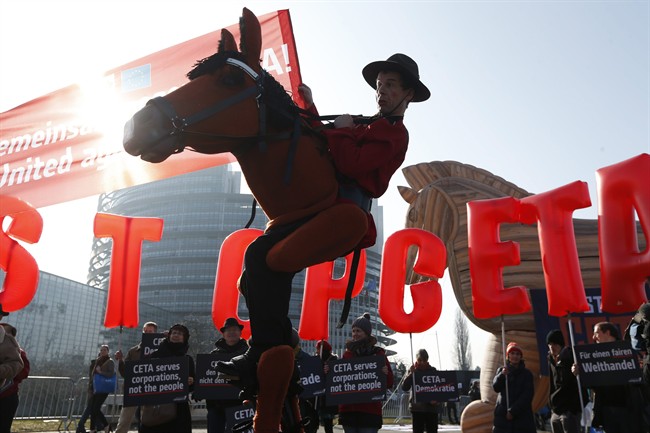 Activists stage a demonstration against CETA, the Canada-EU trade deal, outside the European Parliament in Strasbourg, eastern France, Wednesday, Feb. 15, 2017. Will extent to which the trade deal will help Canadians is yet to be seen.