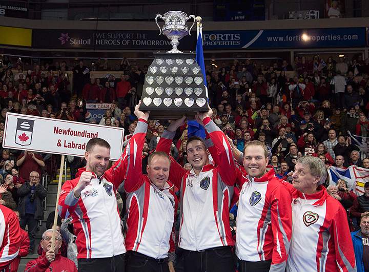 Newfoundland and Labrador’s Brad Gushue, Mark Nichols, Brett Gallant, Geoff Walker and coach Jules Owchar, left to right, hold the Brier Tankard after defeating Team Canada 7-6 at Mile One Centre in St. John’s on Sunday, March 12, 2017.