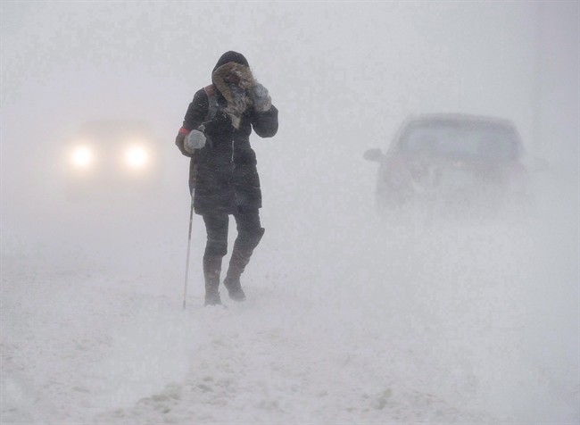 A pedestrian walks down Brunswick Street near Citadel Hill in Halifax as a major winter storm blasts the Maritimes on Monday, Feb. 13, 2017. 