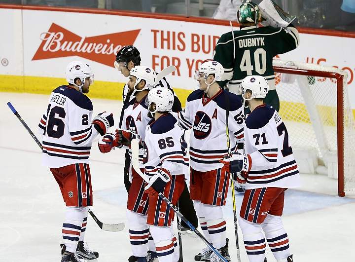 Blake Wheeler, Dustin Byfuglien, Mathieu Perreault, Mark Scheifele and Julian Melchiori of the Winnipeg Jets celebrate a second period goal against the Minnesota Wild at MTS Centre on Sunday.