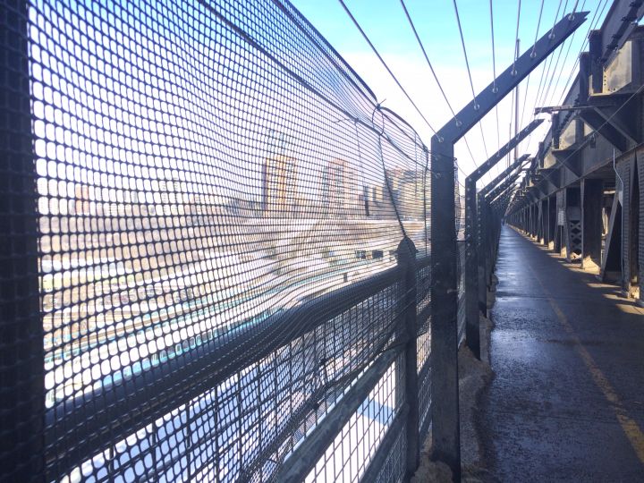 Temporary mesh fencing covers a gaping hole in the High Level Bridge suicide barriers Wednesday, March 15, 2017. 