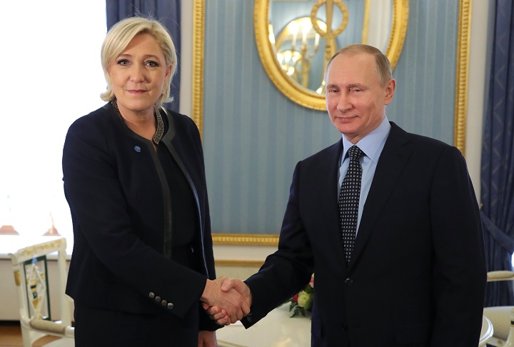 Russian President Vladimir Putin shakes hands with Marine Le Pen, French National Front (FN) political party leader and candidate for the French 2017 presidential election, during their meeting in Moscow, Russia March 24, 2017. 