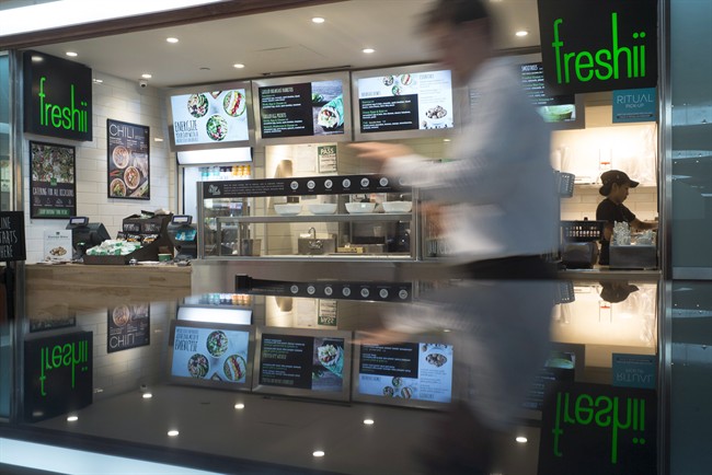 A man walks by a Freshii restaurant in Toronto on Tuesday, March 21, 2017. 