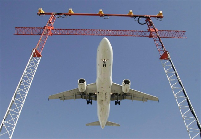 An Air Canada flight makes its final approach as it lands at Pearson International Airport in Toronto on Sept. 30, 2004. Even with travel insurance, Canadians are likely not covered for being bumped off an overbooked flight.