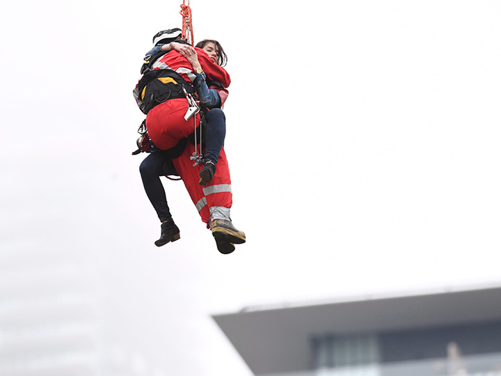 A woman is rescued from a downtown Toronto crane early Wednesday, April 26, 2017. 