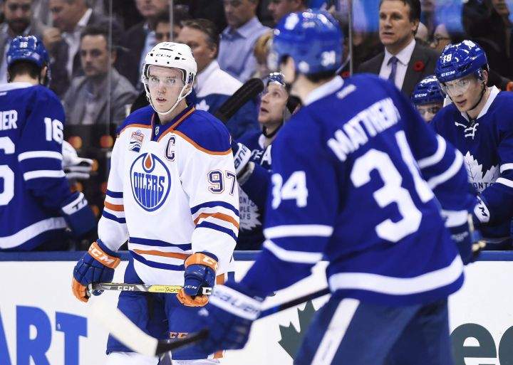 Edmonton Oilers centre Connor McDavid (97) and Toronto Maple Leafs centre Auston Matthews (34) skate during a break in first period NHL hockey action in Toronto on Tuesday, November 1, 2016. 