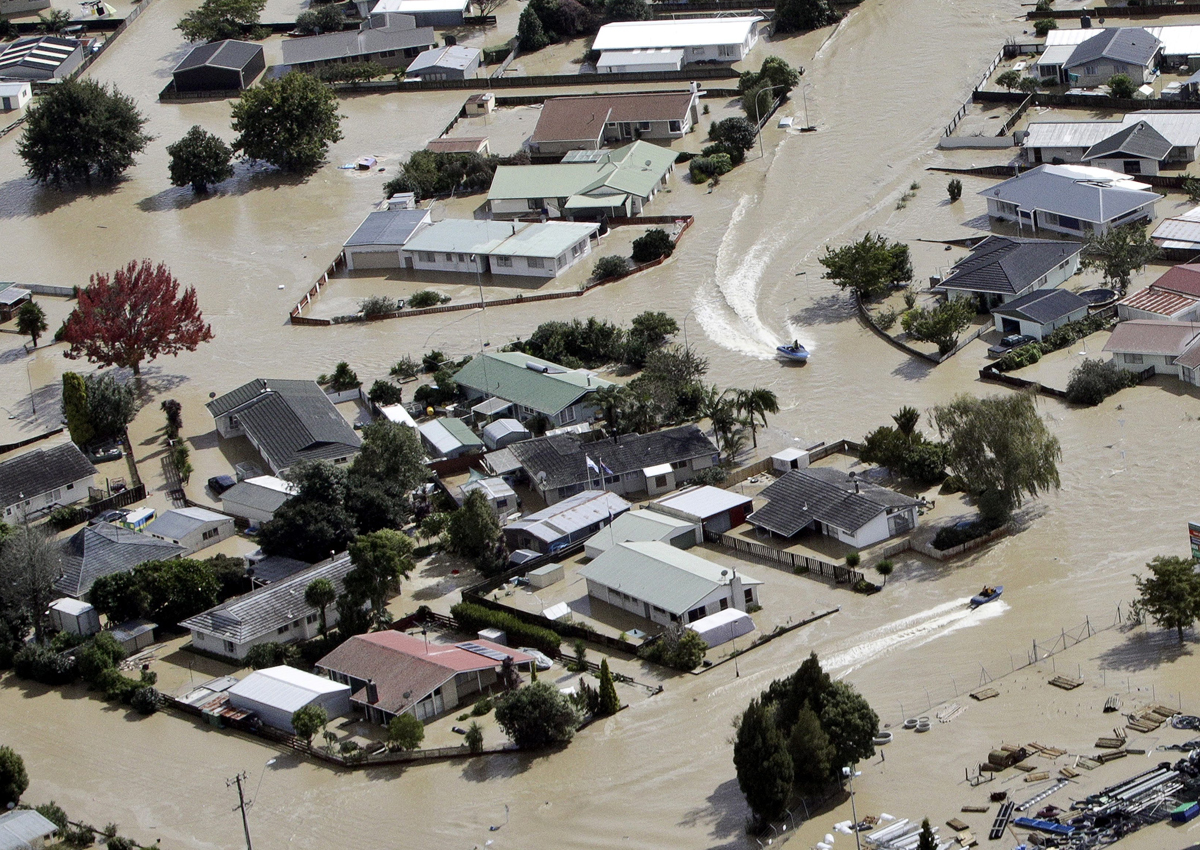 Jet boats drive through the flooded streets of the North Island town of Edgecumbe in New Zealand, Thursday, April 6, 2017. (Andrew Warner/The Bay of Plenty Times via AP)