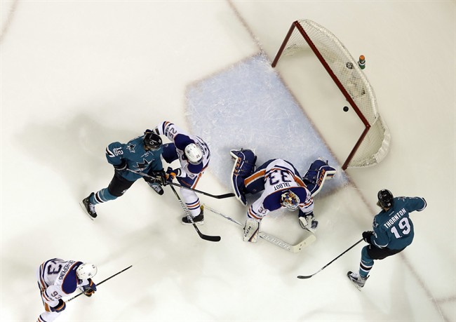 Edmonton Oilers goalie Cam Talbot, center, is beaten for a goal on a shot from San Jose Sharks' Logan Couture, not seen, as Joe Thornton (19), Oilers' Darnell Nurse (25) Sharks' Patrick Marleau (12) and Oilers' Ryan Nugent-Hopkins (93) watch during the first period in Game 4 of a first-round NHL hockey playoff series Tuesday, April 18, 2017, in San Jose, Calif. 
