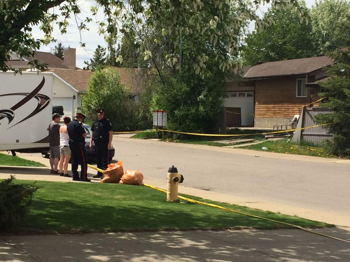Police speak to residents after a collision in a west end neighbourhood, Monday, May 22, 2017.