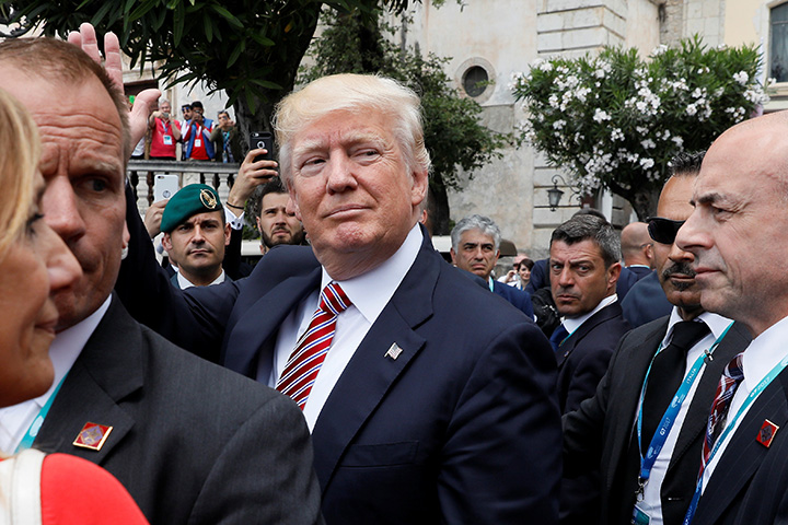 U.S. President Donald Trump waves to onlookers as he attends the G7 Summit in Taormina, Sicily, Italy, May 26, 2017. 