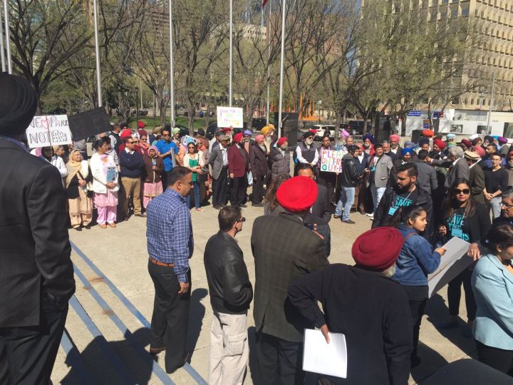 Some 100 people gathered outside city hall on Monday to protest a proposed development next to the Genesis Centre in northeast Calgary.