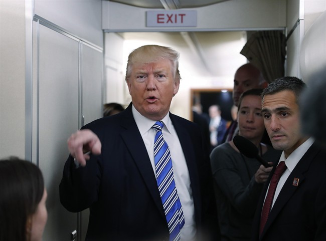 President Donald Trump speaks to members of the media aboard Air Force One before his departure from Andrews Air Force Base, Md., Saturday, May 13, 2017. 