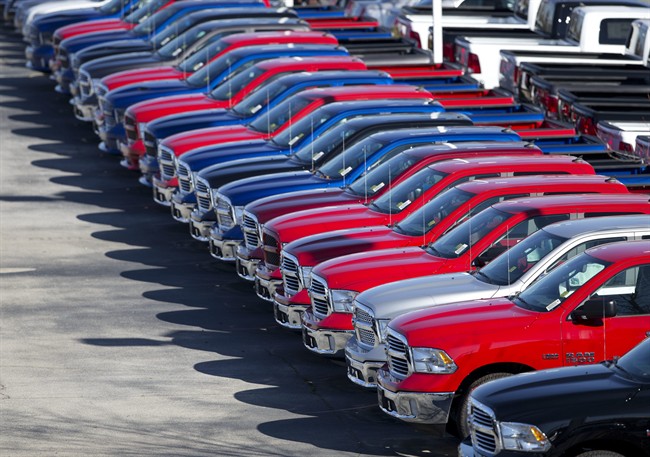 In this Jan. 5, 2015, file photo, Dodge Ram pickup trucks are on display on the lot at Landmark Dodge Chrysler Jeep RAM in Morrow, Ga.
