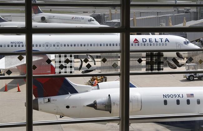 FILE – In this Monday, Aug. 8, 2016, file photo, Delta Air Lines planes are parked at Ronald Reagan Washington National Airport, in Washington.