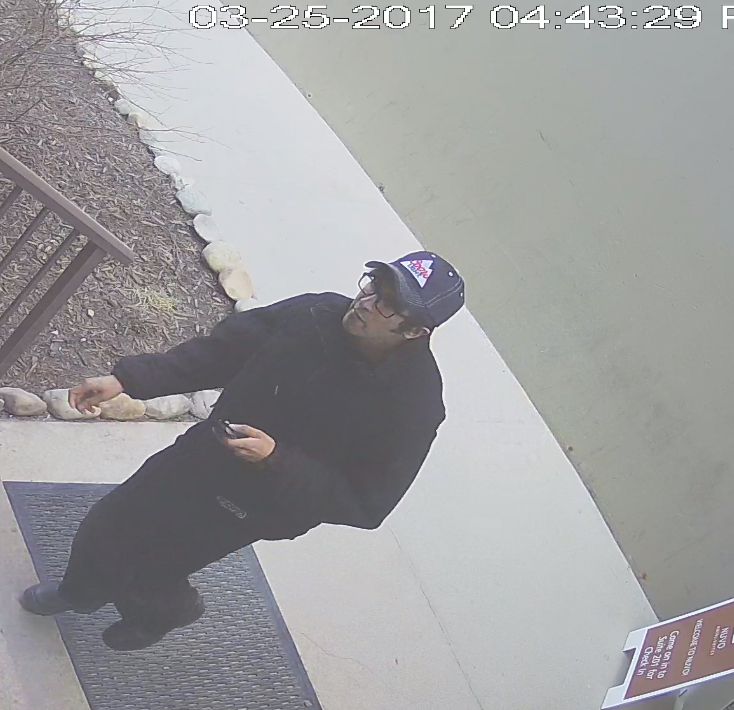 Calgary police have released photos of a man wanted for impersonating an officer to commit robbery.