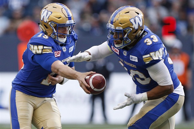 Winnipeg Blue Bombers quarterback Matt Nichols (15) hands off to Andrew Harris (33) during the first half of CFL action against the Edmonton Eskimos, in Winnipeg on June 15, 2017. 