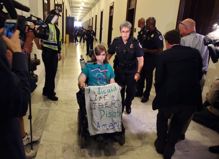 U.S. Capitol Police remove a protester from in front of the office of Senate Majority Leader Mitch McConnell.