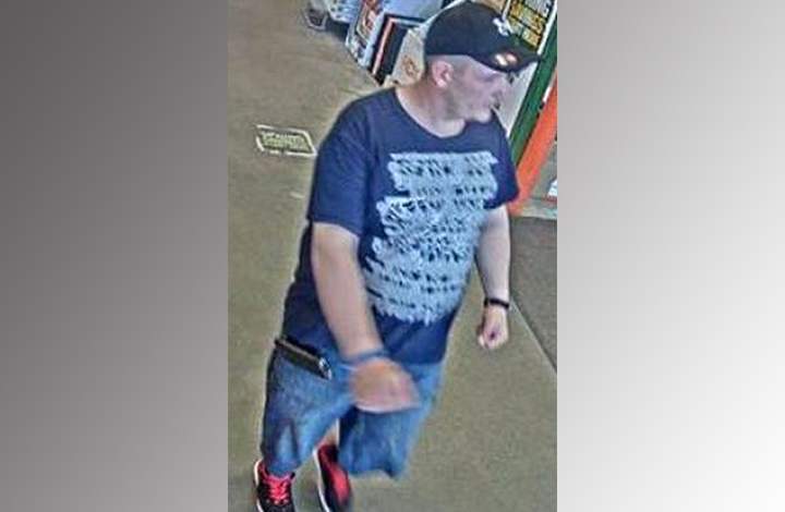 Security camera image of man to be identified in fraud investigation.