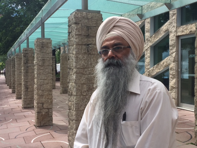 Headway School principal J.S. Sindhu stands outside city hall.