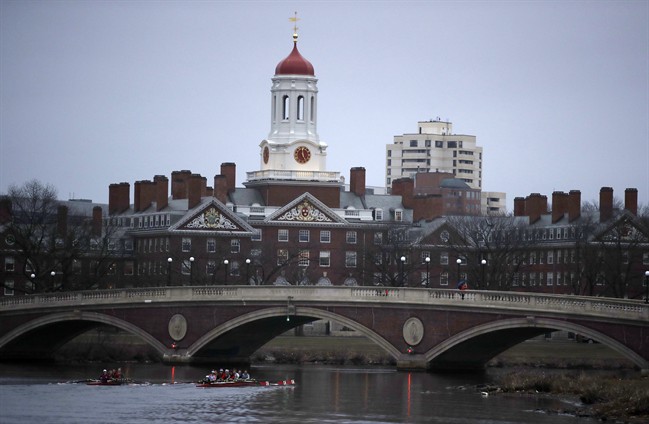 FILE - In this March 7, 2017 file photo, rowers paddle down the Charles River near the campus of Harvard University in Cambridge, Mass.