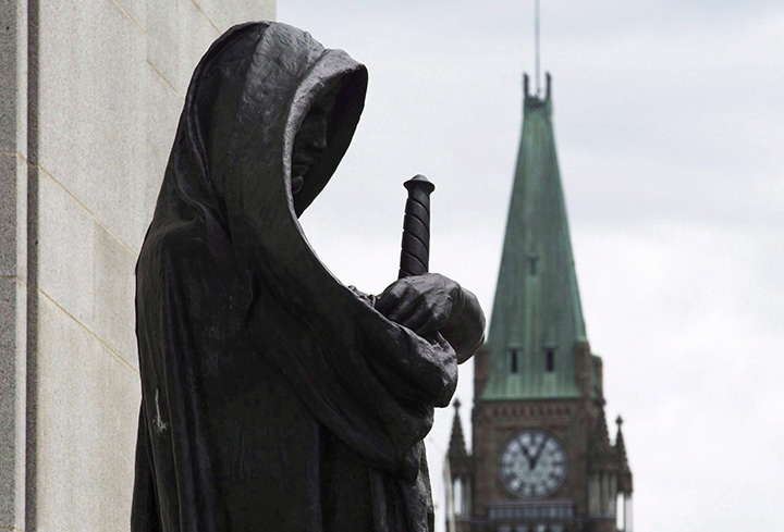 The Peace tower on Parliament Hill is seen behind the justice statue outside the Supreme Court of Canada in Ottawa, Monday June 6, 2016. 
