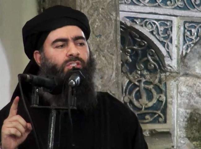 FILE – This file image made from video posted on a militant website Saturday, July 5, 2014, purports to show the leader of the Islamic State group, Abu Bakr al-Baghdadi, delivering a sermon at a mosque in Iraq during his first public appearance.