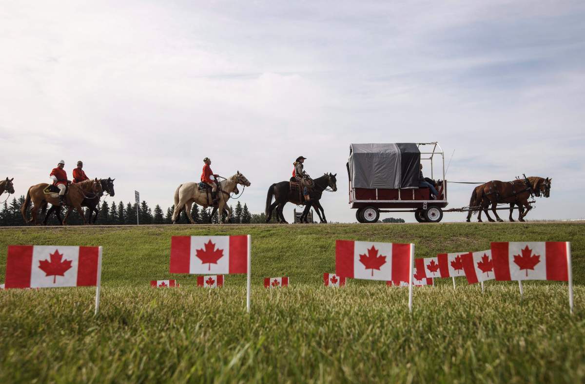 RCMP take part in the re-enactment of the March West, near Fort Saskatchewan, Alta., on June 30, 2017.