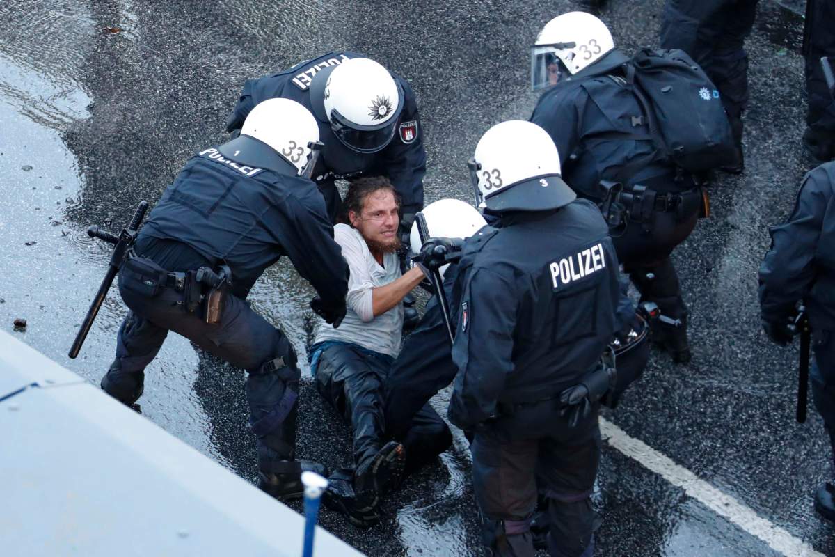 German riot police detain a protester during the demonstrations during the G20 summit in Hamburg, Germany, July 6, 2017. REUTERS/Fabrizio Bensch