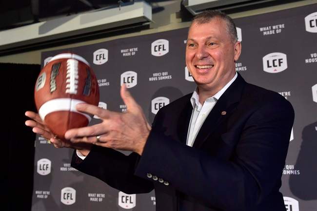 CFL commissioner Randy Ambrosie tosses a football as he speaks during a press conference in Toronto, Wednesday July 5, 2017.