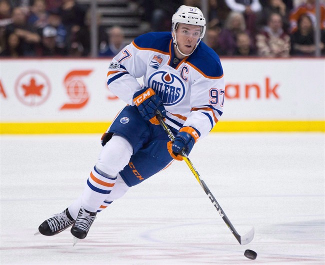 Edmonton Oilers' Connor McDavid skates with the puck during first period NHL hockey action against the Vancouver Canucks, in Vancouver, B.C., on Saturday, April 8, 2017. 