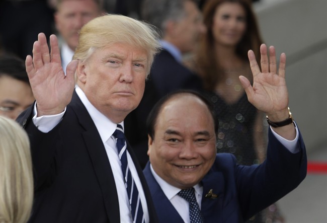 U.S. President Donald Trump, left, and Vietnamese Prime Minister Nguyen Xuan Phuc wave prior to a concert on the first day of the G-20 summit in Hamburg, northern Germany, Friday, July 7, 2017. The leaders of the group of 20 meet July 7 and 8. 