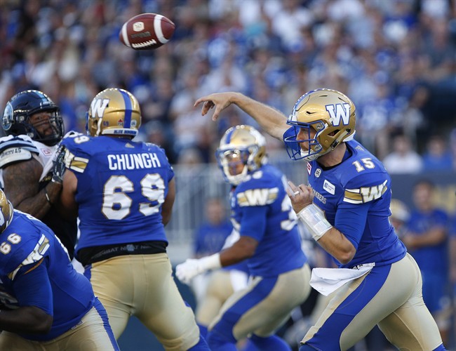 Winnipeg Blue Bombers' quarterback Matt Nichols (15) throws against the Toronto Argonauts during the first half of CFL action in Winnipeg Thursday, July 13, 2017. THE CANADIAN PRESS/John Woods.
