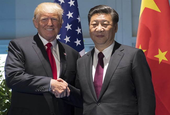 US President Donald Trump and Chinese President Xi Jinping, right, shake hands as they arrive for a meeting on the sidelines of the G-20 Summit in Hamburg, Germany, Saturday, July 8, 2017.