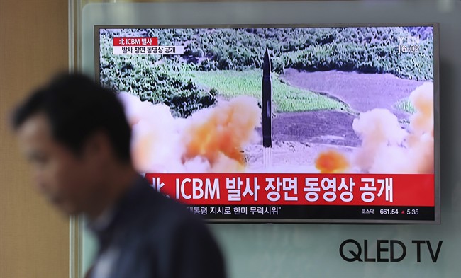A man walks by a TV screen showing a local news program reporting about North Korea's missile firing at Seoul Train Station in Seoul, South Korea, Wednesday, July 5, 2017.