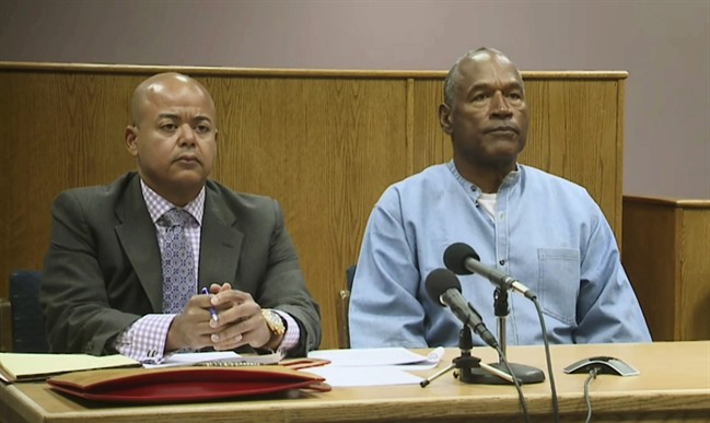 Former NFL football star O.J. Simpson appears with his attorney, Malcolm LaVergne, left, via video for his parole hearing at the Lovelock Correctional Center in Lovelock, Nev., on Thursday, July 20, 2017.