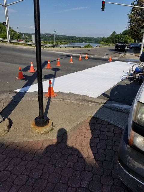 Work starts on repainting the rainbow crosswalk in Woodstock, N.B. after it was vandalized over the weekend.