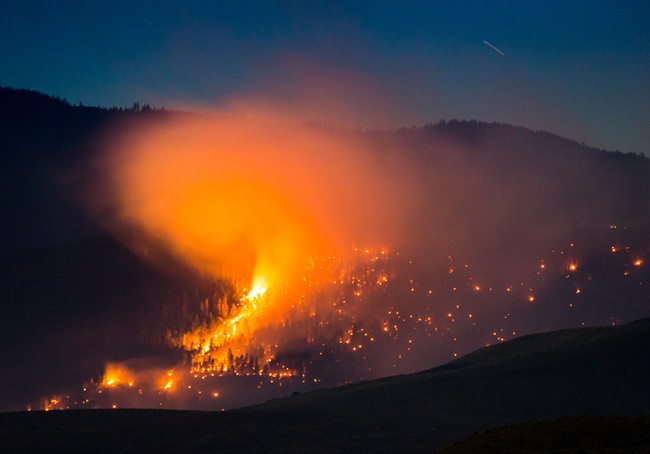 A wildfire burns on a mountain near Ashcroft, B.C., late Friday July 7, 2017.