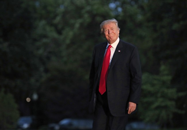 President Donald Trump smiles as he walks on the South Lawn upon arrival the White House in Washington on July 8, 2017, .