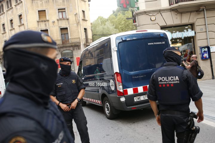 A police van drives away with a detained suspect after a search of a building in Ripoll, north of Barcelona, Spain, Friday, Aug. 18, 2017.