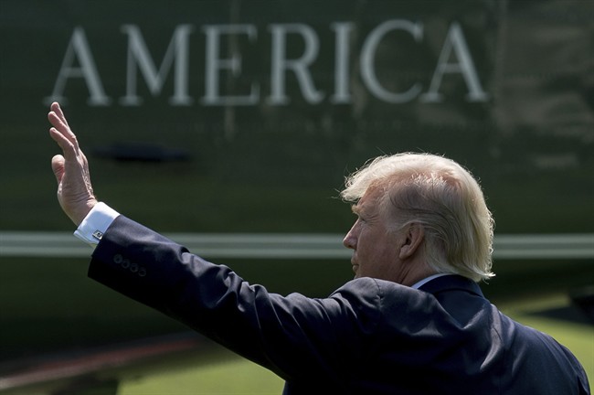 In this Tuesday, Aug. 22, 2017, file photo, President Donald Trump waves as he walks across the South Lawn of the White House in Washington to board Marine One for a short trip to Andrews Air Force Base, Md.