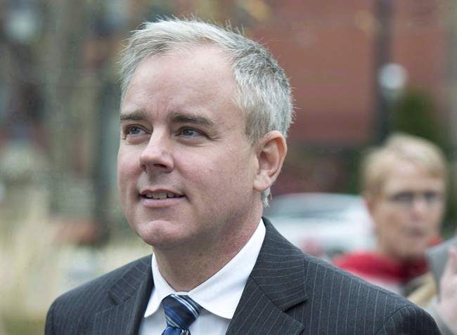 Dennis Oland heads from a bail hearing after being released from custody in Fredericton on Tuesday, Oct. 25, 2016.