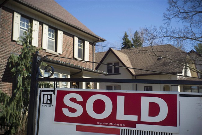 A sold sign is shown in front of west-end Toronto homes Sunday, April 9, 2017.