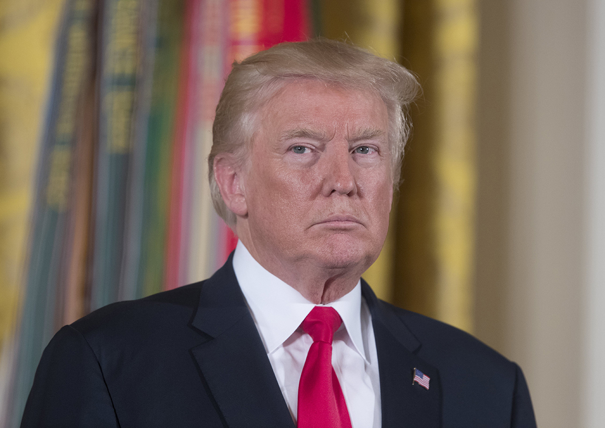 Donald Trump listens to the reading of the citation before awarding the Medal of Honor to US Army medic and Vietnam War veteran James McCloughan (not pictured), during a ceremony in the East Room of the White House.
