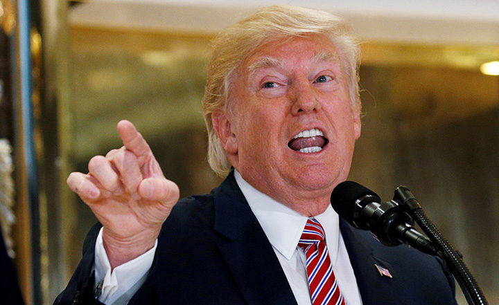 U.S. President Donald Trump answers questions about his response to the violence, injuries and deaths at the "Unite the Right" rally in Charlottesville as he talks to the media in the lobby of Trump Tower in Manhattan, New York, August 15, 2017.   