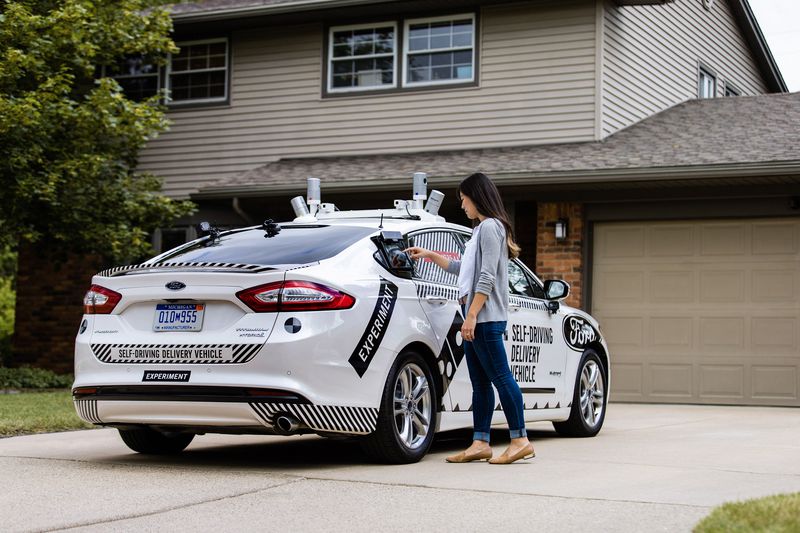 The customer has to input a code into a device on the side of the car and then retrieve the pizza from a special window designed to keep the pizza warm on its trip.