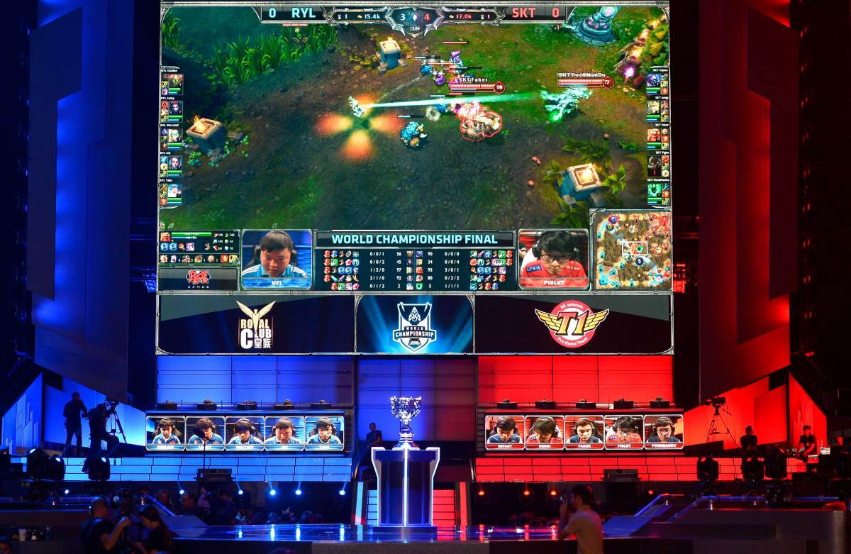 FILE – In this Oct. 4, 2013, file photo, the teams of China’s Royal Club, left, and South Korea’s SK Telecom T1 compete at the League of Legends Season 3 World Championship Final in Los Angeles.