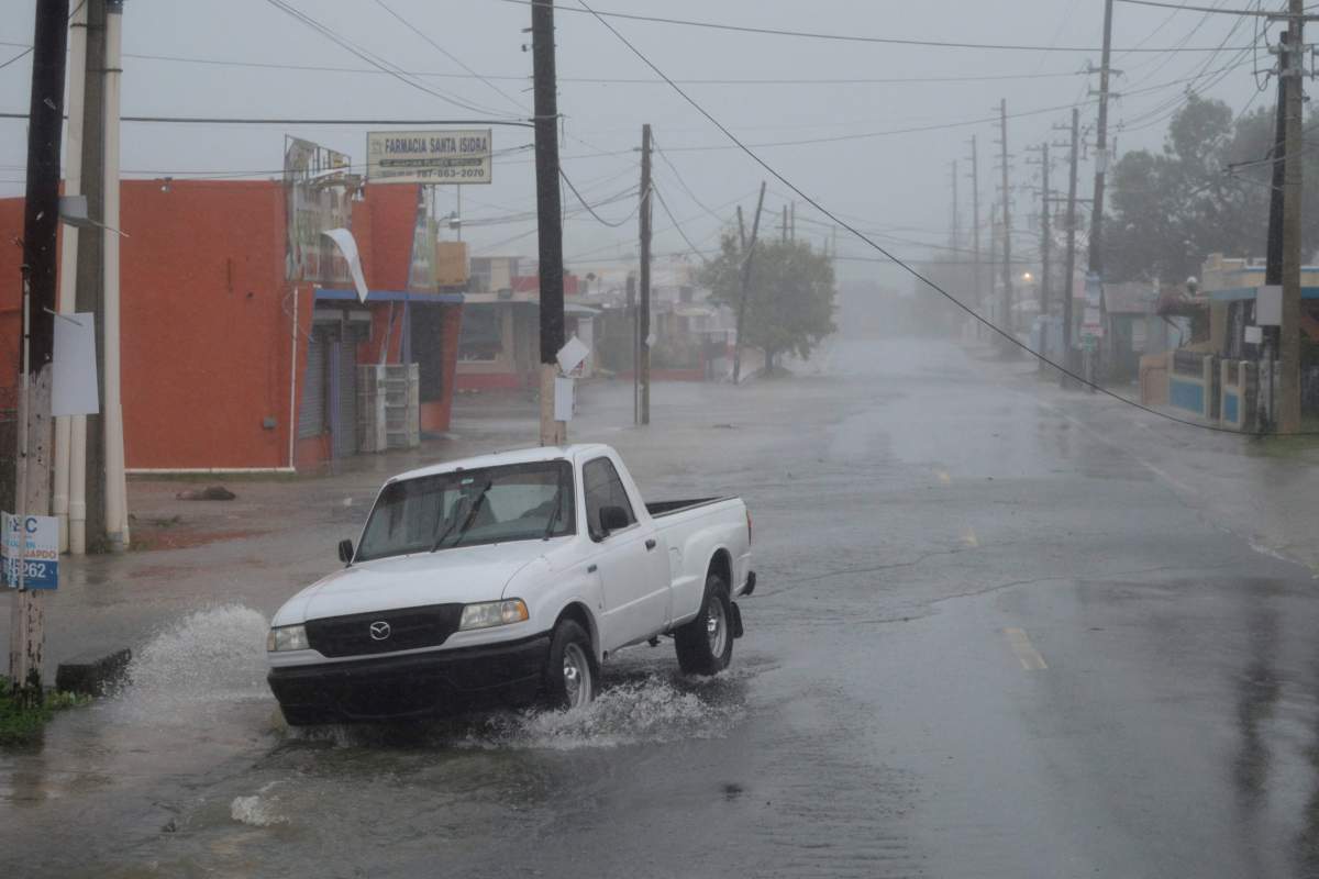 A man drives through rain and strong winds during the passage of hurricane Irma, in Fajardo, Puerto Rico, Wednesday, Sept. 6, 2017.