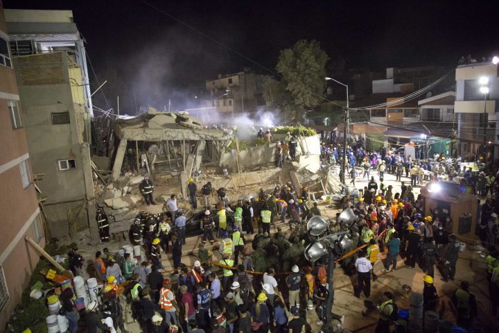 Volunteers and rescue workers search for children trapped inside at the collapsed Enrique Rebsamen school in Mexico City, on Sept. 19, 2017.