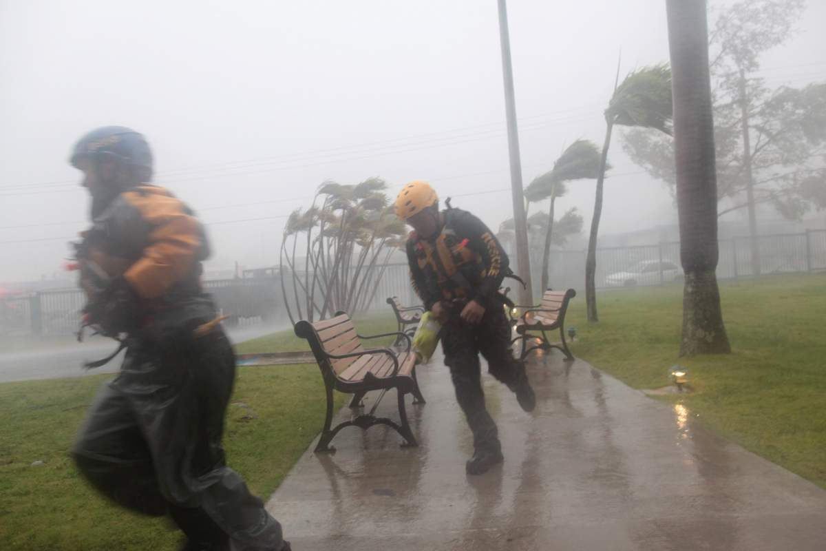 Members of the civil defense run as Hurricane Irma howls past Puerto Rico after thrashing several smaller Caribbean islands, in Fajardo, Puerto Rico September 6, 2017.