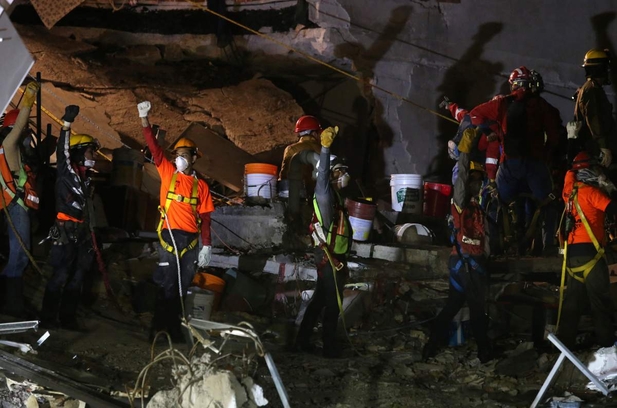 Members of rescue teams work in the rubble of a collapsed building after an earthquake in Mexico City, Mexico September 24, 2017.